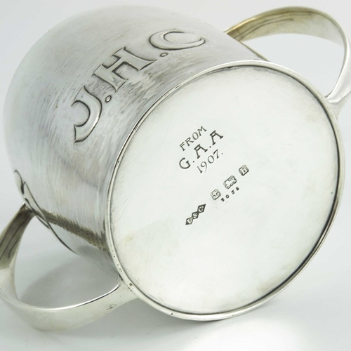 106 - Archibald Knox for Liberty and Co., an Arts and Crafts silver twin handled cup, Birmingham 1907, mod... 