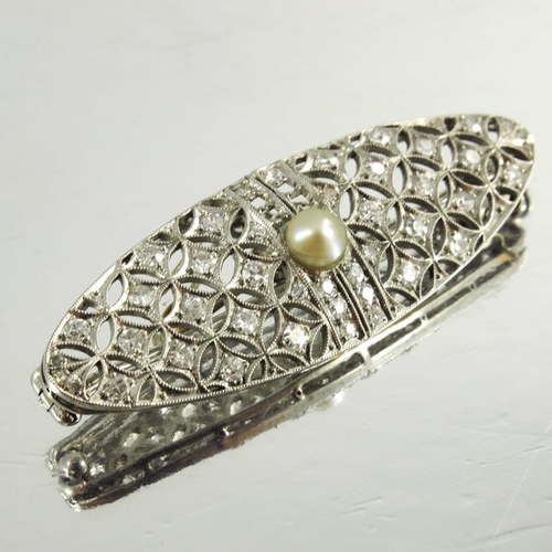 123 - A platinum and diamond brooch, circa 1905, lozenge form, reticulate and set with stones in a milled ... 