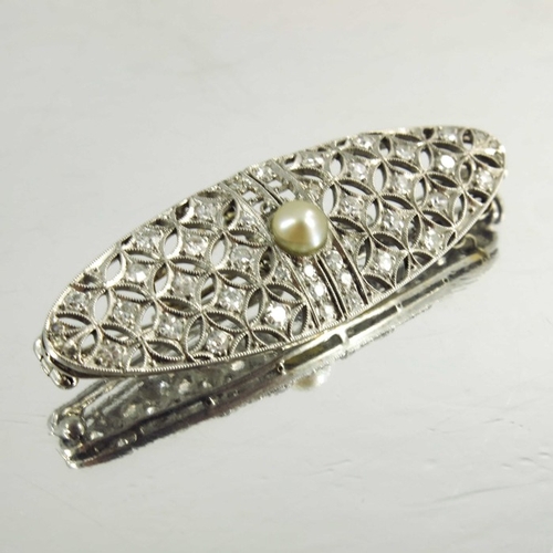 123 - A platinum and diamond brooch, circa 1905, lozenge form, reticulate and set with stones in a milled ... 