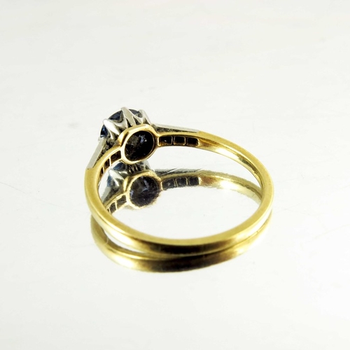 125 - A sapphire and diamond ring, on 18 carat gold band, the central solitaire stone, approx. 6mm diamete... 