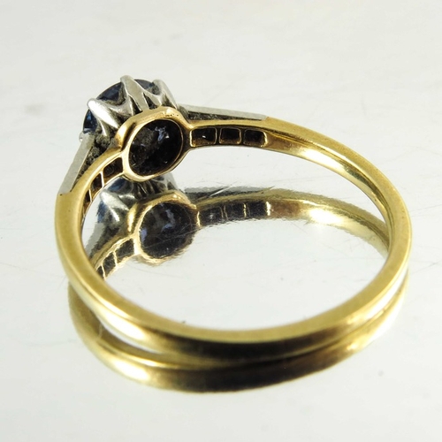 125 - A sapphire and diamond ring, on 18 carat gold band, the central solitaire stone, approx. 6mm diamete... 