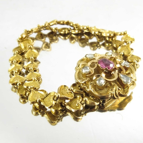 130 - A Victorian gold, diamond and ruby bracelet, the cast heart linked double chain band with foliate sc... 