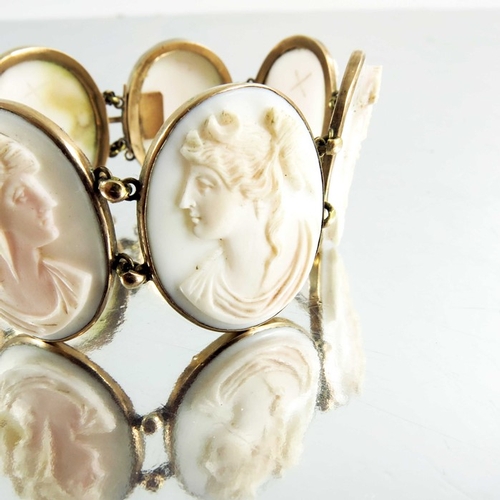 131 - A Victorian yellow metal and cameo set bracelet, seven portrait ovals of Classical women in profile ... 