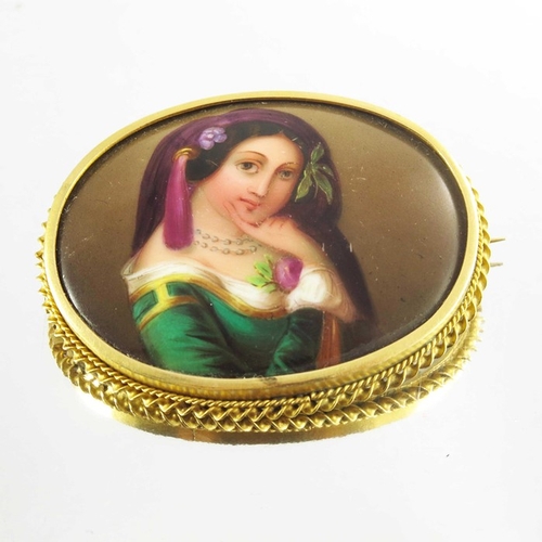 139 - A Victorian Porcelain Brooch mounted in 15ct yellow gold, the oval lozenge depicting a portrait imag... 