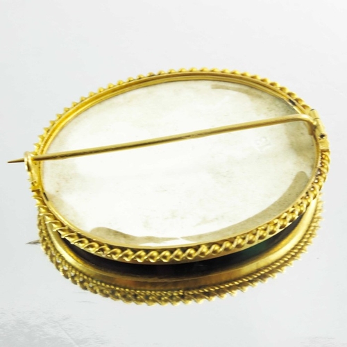 139 - A Victorian Porcelain Brooch mounted in 15ct yellow gold, the oval lozenge depicting a portrait imag... 