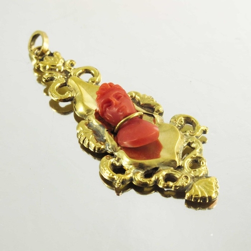 140 - A Victorian Yellow Gold Drop Pendant with carved coral Romanesque bust, in Rococo style the bust sec... 