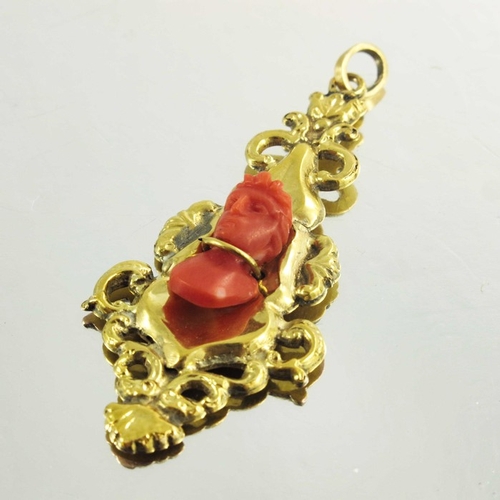 140 - A Victorian Yellow Gold Drop Pendant with carved coral Romanesque bust, in Rococo style the bust sec... 