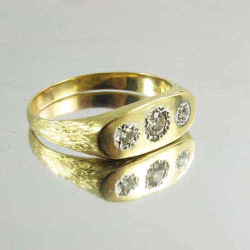 142 - A Gentleman's 18ct yellow gold three stone diamond ring, the central old cut diamond surmounted by t... 