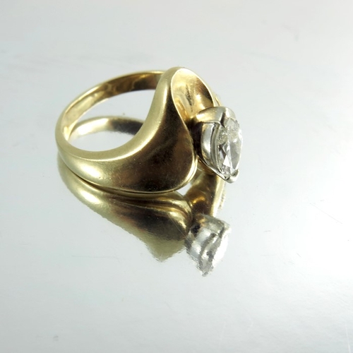 149 - An 18 carat gold and diamond modernist ring, Marquise cut stone with channel set rose cut, approx. s... 