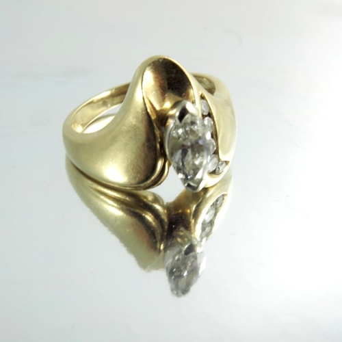 149 - An 18 carat gold and diamond modernist ring, Marquise cut stone with channel set rose cut, approx. s... 