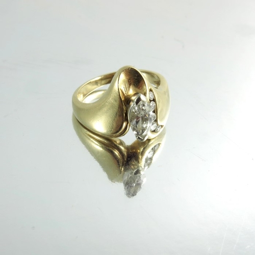 149 - An 18 carat gold and diamond modernist ring, Marquise cut stone with channel set rose cut, approx. s... 