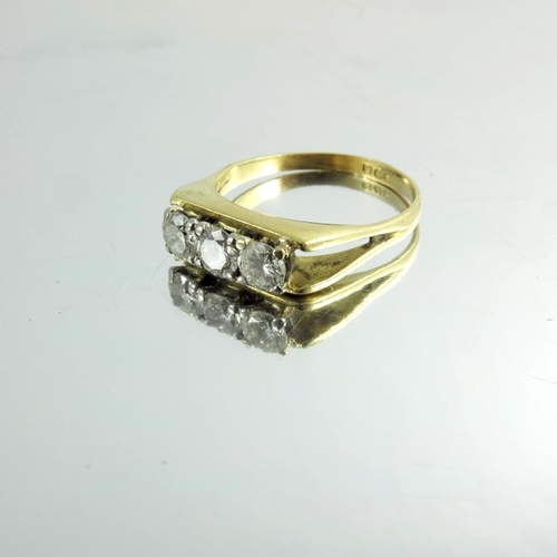 150 - An 18 carat gold and three stone diamond ring, channel claw set, approx size L