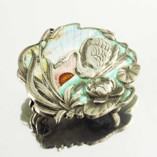 158 - A Continental Art Nouveau silver and enamelled brooch, cast in relief with a swan in a lily pond, gu... 