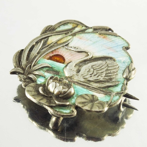 158 - A Continental Art Nouveau silver and enamelled brooch, cast in relief with a swan in a lily pond, gu... 