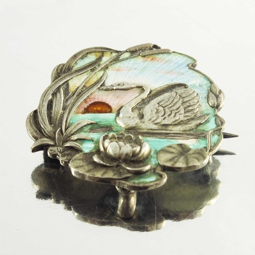 158 - A Continental Art Nouveau silver and enamelled brooch, cast in relief with a swan in a lily pond, gu... 