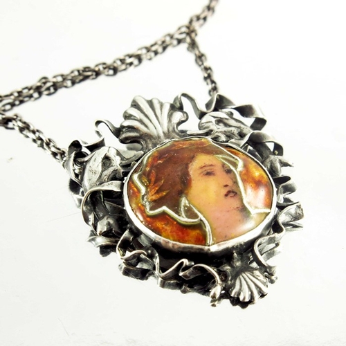 160 - An Art Nouveau silver and enamelled pendant necklace, the cloisonne roundel of a womans head within ... 