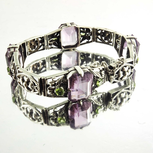 163 - Sybil Dunlop, an Arts and Crafts silver, amethyst and peridot bracelet, emeral cut purple stones in ... 