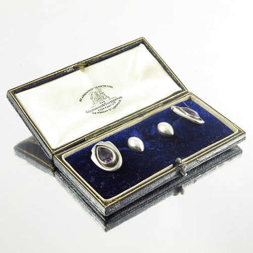 169 - Kalo Shop, a pair of Arts and Crafts silver and amethyst cufflinks, teardrop stones within shiled sh... 