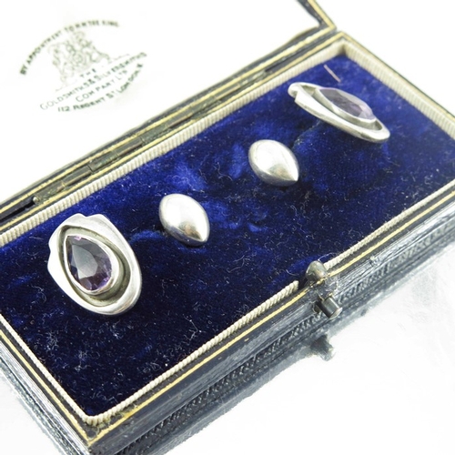 169 - Kalo Shop, a pair of Arts and Crafts silver and amethyst cufflinks, teardrop stones within shiled sh... 