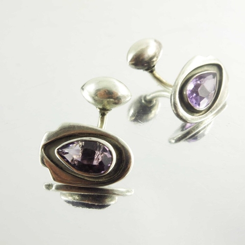 169 - Kalo Shop, a pair of Arts and Crafts silver and amethyst cufflinks, teardrop stones within shiled sh... 