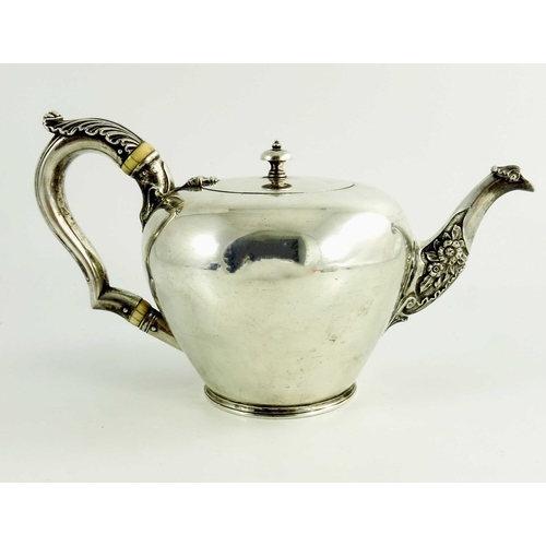 21 - A mid 18th century Scottish provencial silver teaport, circular shape, floral decoration to the spou... 