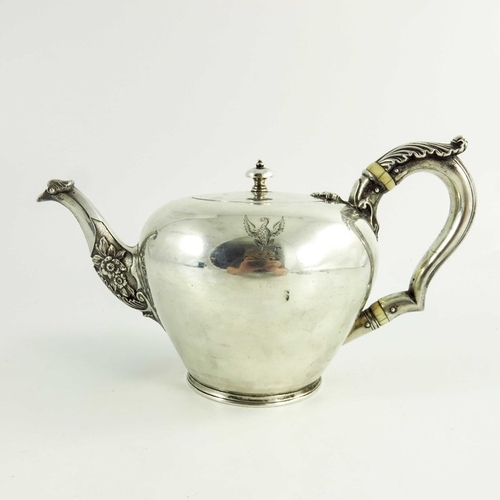 21 - A mid 18th century Scottish provencial silver teaport, circular shape, floral decoration to the spou... 