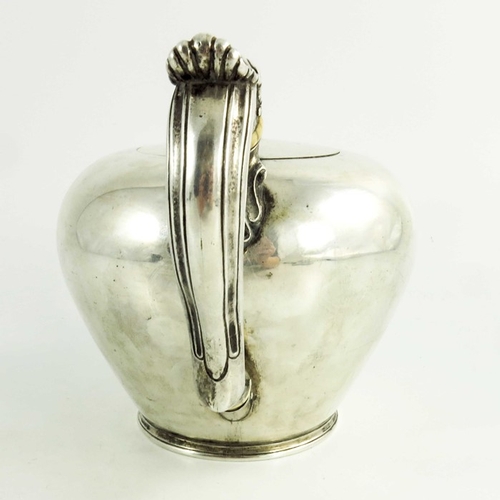 21 - A mid 18th century Scottish provencial silver teaport, circular shape, floral decoration to the spou... 