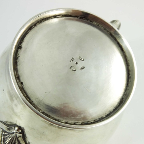 21 - A mid 18th century Scottish provencial silver teaport, circular shape, floral decoration to the spou... 