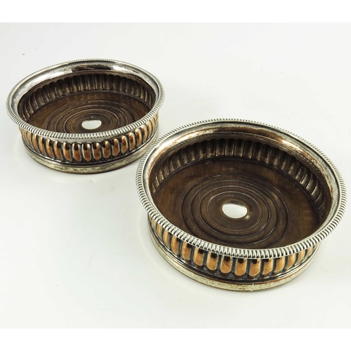 3 - A pair of George IV Old Sheffield Plate wine coasters, circa 1820, reeded bodies with gadrooned rims... 