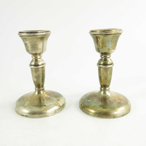 45 - A pair of George V silver dwarf candlesticks, W I Broadway and Co., Birmingham 1931, turned cup and ... 