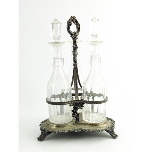 5 - A William IV silver plate three decanter cruet, slice cut glass bottles, together with a galleried o... 