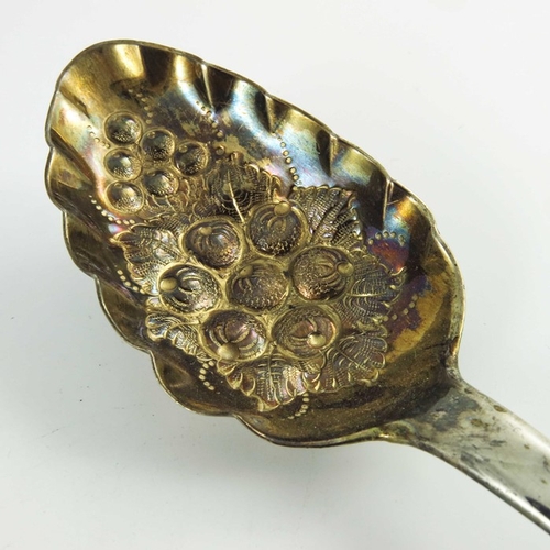 52 - A George III Scottish silver berry spoon, Edinburgh 1812, fiddle pattern, later embossed and gilt be... 