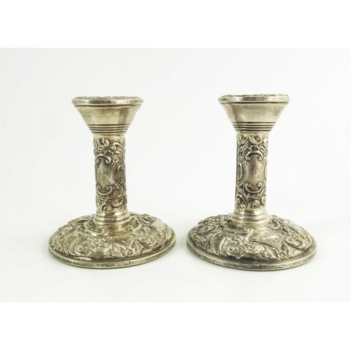 54 - A pair of Elizabeth II silver dwarf candlesticks, W I Broadway and Co., Birmingham 1969, heavily emb... 