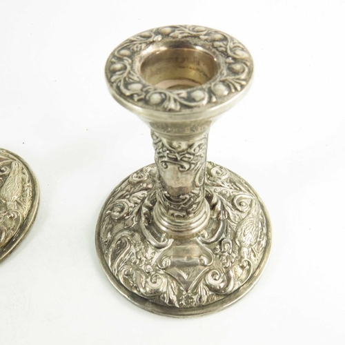 54 - A pair of Elizabeth II silver dwarf candlesticks, W I Broadway and Co., Birmingham 1969, heavily emb... 