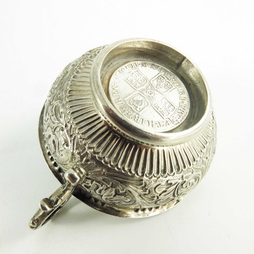 56 - An 18th century two handled white metal bowl, the base set with a Queen Anne silver shilling, 1711, ... 