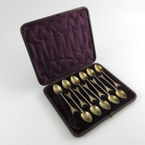 65 - A set of eleven Victorian silver gilt teaspoons, Martin, Hall and Co., Sheffield 1874, cast in the f... 