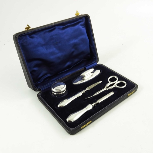 70 - A George V silver manicure set, Samuel M Levi, Birmingham 1919, including glass jar, in fitted velve... 