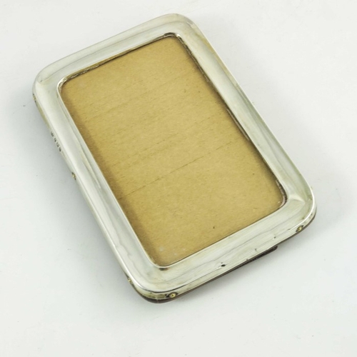 71 - An Edwardian silver photo frame, William Adams, Birmingham 1902, plain rectangular form with rounded... 