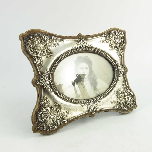 75 - An Edwardian silver photo frame, W J Myatt, Birmingham 1905, shaped butterfly ogee form, embossed wi... 