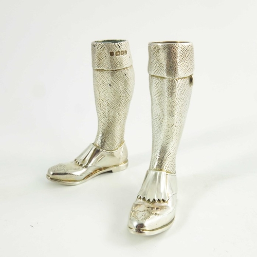 97 - A pair of silver novelty condiments, modelled as legs, together with a silver bottle top, Theo Thenn... 