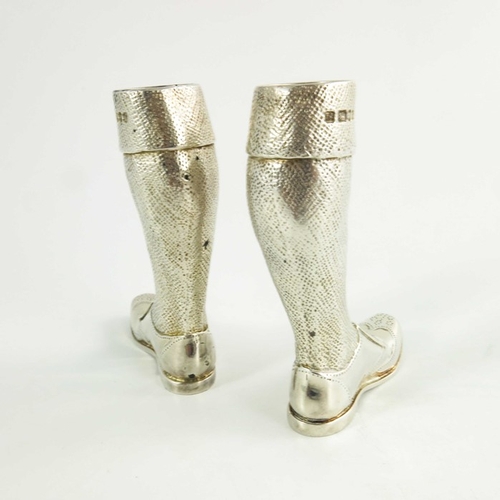 97 - A pair of silver novelty condiments, modelled as legs, together with a silver bottle top, Theo Thenn... 