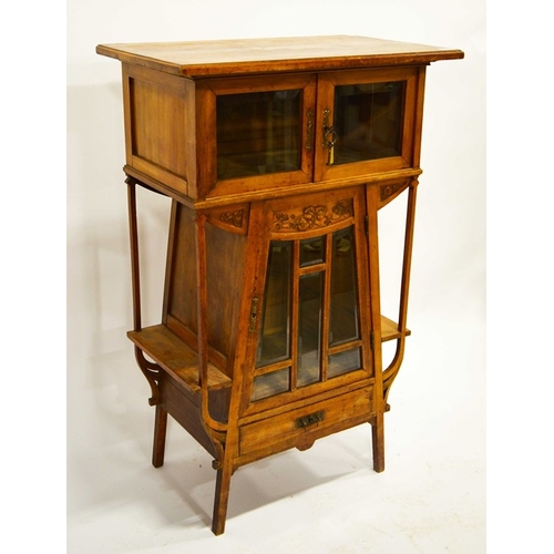 219 - A French Art Nouveau cabinet, circa 1900, the tapered triangular form body, flanked by shelves, belo... 