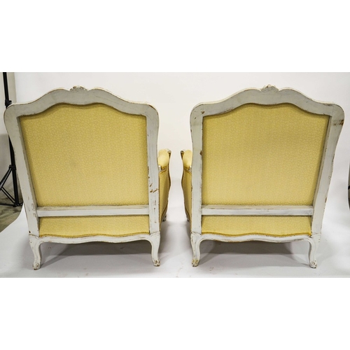 225 - A pair of Louis XV style French upholstered armchairs, white painted, ogee backs, on squat cabriole ... 