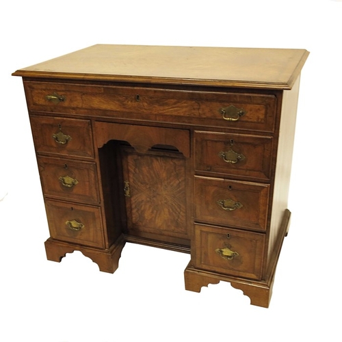 231 - A George I style walnut kneehole desk, the single long drawer over two sets of three short drawers, ... 