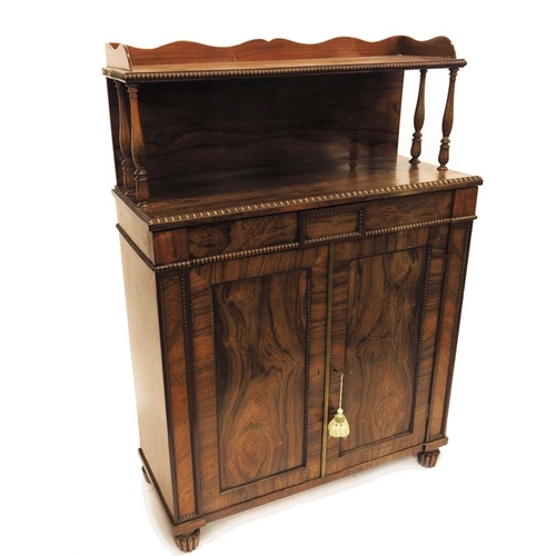 235 - A William IV rosewood chiffonier, circa 1835, the panelled cupboard doors opening to reveal a shelve... 