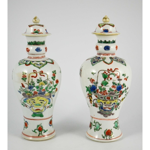 381 - A Pair of Chinese Famille Vert Baluster Vases and Covers, each decorated with floral motifs in polyc... 