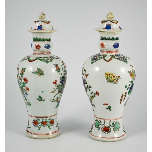 381 - A Pair of Chinese Famille Vert Baluster Vases and Covers, each decorated with floral motifs in polyc... 