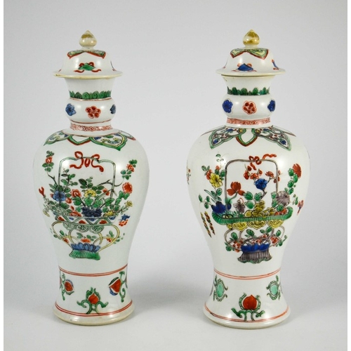 381 - A Pair of Chinese Famille Vert Baluster Vases and Covers, each decorated with floral motifs in polyc... 