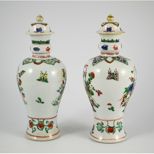 381 - A Pair of Chinese Famille Vert Baluster Vases and Covers, each decorated with floral motifs in polyc... 