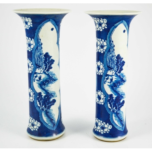 383 - A pair of Chinese blue and white sleeve vases, flared trumpet form, prunus grounds with lobed navett... 